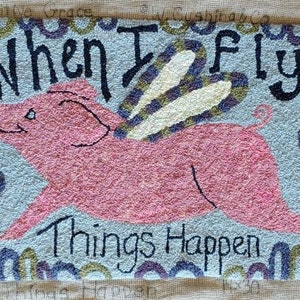 May include: Hand-hooked rug featuring a pink pig with wings, the text "When I Fly Things Happen," and a decorative border. The rug is approximately 16 inches by 30 inches.