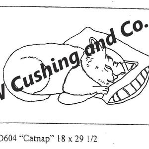 May include: A black and white line drawing of a cat sleeping on a pillow. The cat is curled up, with its eyes closed. The pillow has a striped border. The text "W Cushing and Co." is in the upper left corner. The text "SD604 "Catnap" 45.7 x 74.9 cm" is at the bottom.