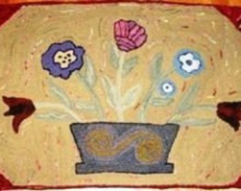May include: A rectangular rug with a floral design. The rug features a beige background with a central vase holding flowers in shades of purple, blue, and pink. The border is a deep red, and the rug is likely made of wool.