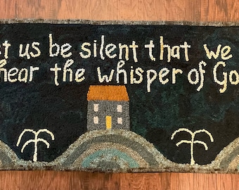 May include: A black and blue rug with a house and trees. The rug has the text "Let us be silent that we may hear the whisper of God" in white.