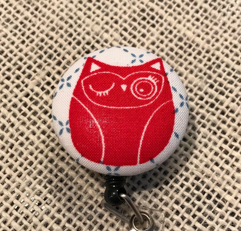 Winking owl button badge reel Comes in red or blue!