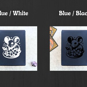 May include: Two blue card cases with a mouse and flower design. One case has a white design, and the other has a black design. The text "Blue / White" and "Blue / Black" are at the top. Dice and cards are in the background.