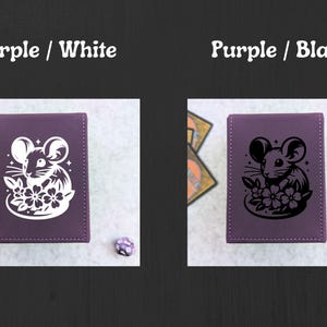 May include: Two purple card cases with a mouse and flower design. One case has a white design, and the other has a black design. The text "Purple / White" and "Purple / Black" are above the cases. A die is next to each case.