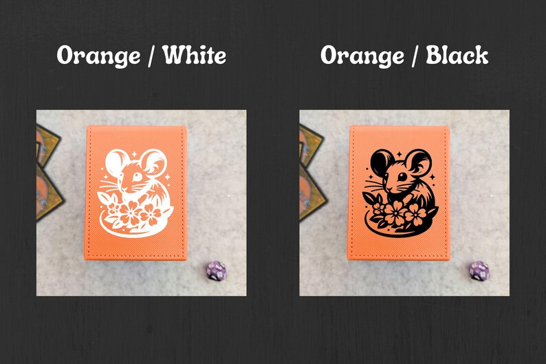 May include: Two orange card holders with a mouse and flower design. One has a white design, the other a black design. The text "Orange / White" and "Orange / Black" is above each card holder.