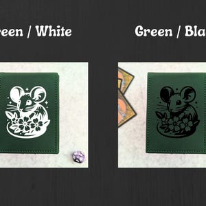 May include: Two green card holders with a mouse and flower design. One has a white design, the other a black design. The text "Green / White" and "Green / Black" is above each card holder. A die is next to each card holder.