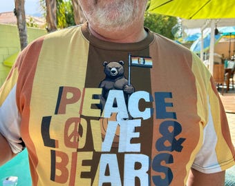 May include: A person wearing a striped shirt with a brown bear graphic and the text "Peace Love & Bears". The shirt has yellow, brown, and white stripes.
