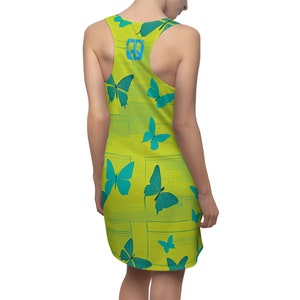 May include: A sleeveless yellow dress with a pattern of blue butterflies. The dress has a scoop neck and a relaxed fit.