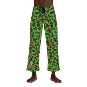 May include: Green pajama pants with a holly and berry pattern. A small Santa Claus graphic is on the left leg.