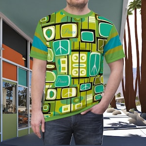 May include: A green short-sleeved t-shirt with a retro geometric pattern in shades of green, brown, and blue. The pattern includes peace signs and the word "Peace" repeated twice.