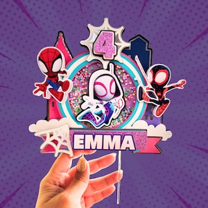 May include: A colorful cake topper featuring Spider-Man characters. The design includes a central bubble with confetti, the number 4, and the name "EMMA". The background is a purple comic book style.