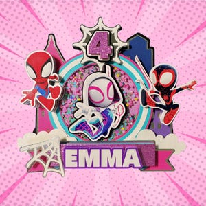 May include: A colorful cake topper featuring Spider-Man characters. The design includes the number 4, the name "EMMA", and various superhero figures. The background is pink with a comic book style design.