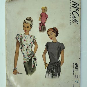May include: Vintage McCall's printed pattern for a Misses' Blouse, size 14. The illustration shows three women wearing different blouse designs. The pattern cover is aged with the text "McCall Printed Pattern".