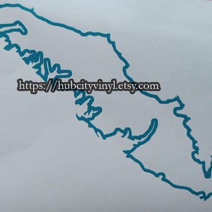 May include: A teal blue vinyl decal of the outline of Vancouver Island, Canada. The decal is on a white background. The text "https://hubcityvinyl.etsy.com" is printed below the decal.