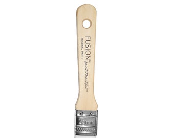 May include: A wooden-handled paint brush with a white bristle head. The handle is labeled "FUSION™ Mineral Paint paint it beautiful™" and "25mm".