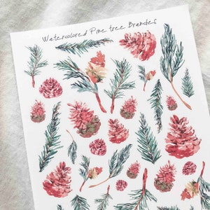 May include: Watercolored Pine tree Branches sticker sheet with various pine branches and pine cones in shades of green and pink.