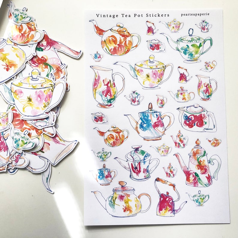 May include: A sheet of vintage tea pot stickers with watercolor illustrations of teapots in various colors and patterns. The stickers are on a white background and have the text "Vintage Tea Pot Stickers" and "peartateapaperie" printed on them.