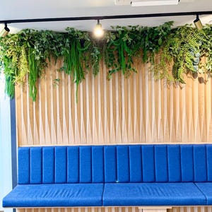 Luxury faux greenery garland with trailing ferns and layered foliage installed