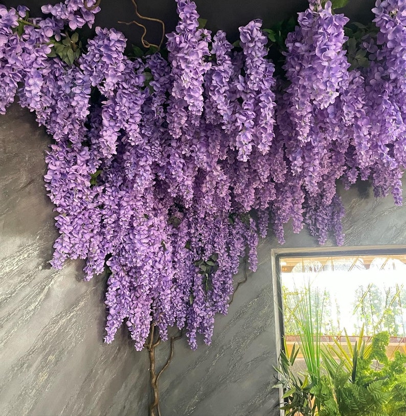 artificial purple wisteria flower garland used to decorate indoor space ( restaurant)