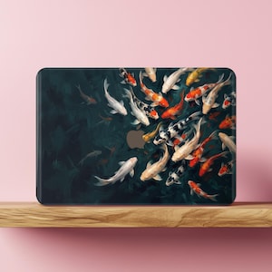 May include: A rectangular laptop skin featuring a dark, deep blue and black background with a school of koi fish swimming in various directions. The fish are depicted in shades of white, orange, red, and black, creating a vibrant contrast.