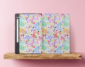 May include: A black tablet case and cover with a colorful pattern of whimsical sea creatures, seashells, and aquatic plants. The design features pastel shades of blue, green, pink, and yellow on a white background. The tablet case has a stylus.