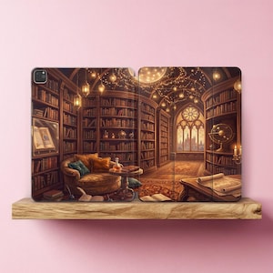 May include: A tablet case featuring a printed illustration of a library interior with tall wooden bookshelves, a cozy armchair, a round table, a large arched window, and warm hanging lights. The design includes an open book and a globe.