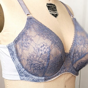 Może przedstawiać: Jasny błękitny biustonosz z koronki z białymi fiszbinami i regulowanymi ramiączkami. Biustonosz ma kwiatowy wz&oacute;r i jest wykonany z miękkiego, elastycznego materiału.