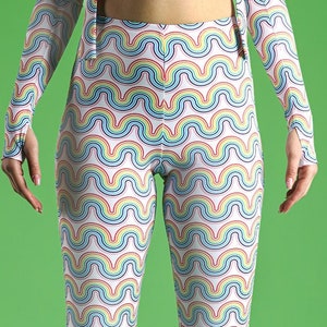 May include: White flared pants with a rainbow wave pattern.