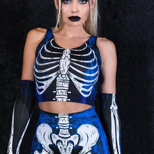 May include: A blue and black skeleton print crop top and leggings set. The top is sleeveless and the leggings are full length.