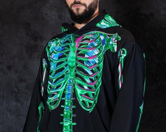 May include: Black hoodie with a green and iridescent skeleton graphic print. The hoodie has a drawstring hood and long sleeves.