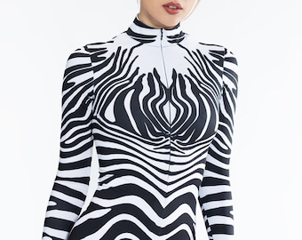 May include: A black and white zebra print jumpsuit with a zipper up the front. The jumpsuit has long sleeves and a high neck.