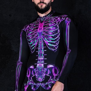 May include: A person wearing a black long-sleeved jumpsuit with a purple and green skeleton design.