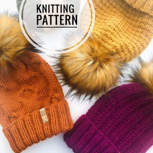 May include: Three knitted hats with faux fur pom poms. The hats are in shades of orange, mustard yellow, and burgundy. The hats have a knitted cable pattern. The orange hat has a leather tag that says "Weird Sheep". The image includes the text "Knitting Pattern".