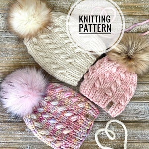 May include: Three knitted hats with faux fur pom poms. The hats are in shades of pink and white. The hats are on a wooden surface. The text "Knitting Pattern" is visible in the image.