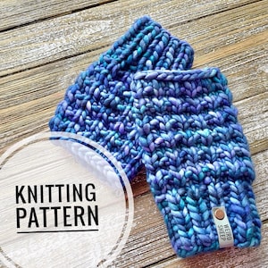 May include: Knitting pattern for a pair of blue and purple fingerless gloves with a "Weird Sheep" tag attached.