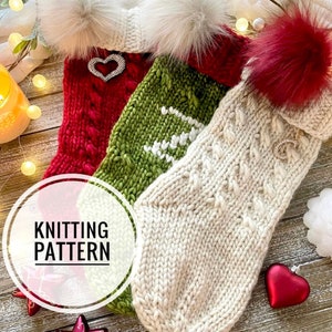 May include: Three knitted Christmas stockings with faux fur pom-poms. The stockings are red, green, and white with different cable knit patterns. The stockings are decorated with jeweled hearts.