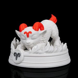 May include: A white 3D-printed sculpture of the Aries zodiac sign. The ram has red horns and tail, and the Aries symbol is on the base. The sculpture is set against a black background.