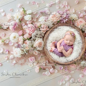 May include: A newborn baby girl sleeping in a wooden bowl lined with white faux fur, surrounded by pink and white flowers and petals.