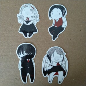 May include: Four cartoon stickers featuring characters with various outfits and hairstyles. One character has long, wavy blonde hair and a black dress. Another is seated, wearing a red vest. A third has a black mask, and the last has wings.