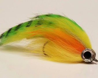 May include: A yellow, orange, and green fly fishing lure with a black and silver hook.