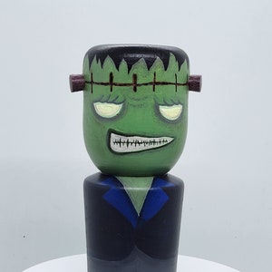 A handmade lathed kokeshi style inspired wooden doll as Frankenstein