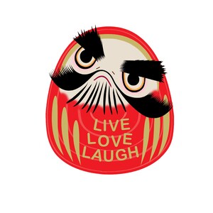 May include: A red and gold daruma doll with a black mustache and eyebrows. The doll has a white face with black eyes and a gold mouth. The doll is looking to the right. The words "Live Love Laugh" are written in gold on the doll's belly.