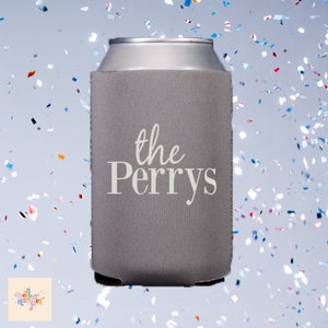 May include: Grey can cooler with the text "the Perrys" in white lettering.