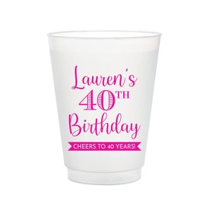 May include: White plastic cup with pink text that reads "Lauren's 40th Birthday Cheers to 40 Years!"
