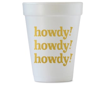 May include: White foam cup with the word "howdy!" repeated three times in gold lettering.