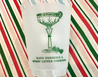 May include: White plastic cup with a green illustration of a martini glass with a candy cane garnish. The text "Have yourself a merry little cocktail" is printed below the glass.