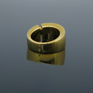 May include: A gold ring with a smooth, rounded band. The ring is marked with the number "585" on the inside of the band.