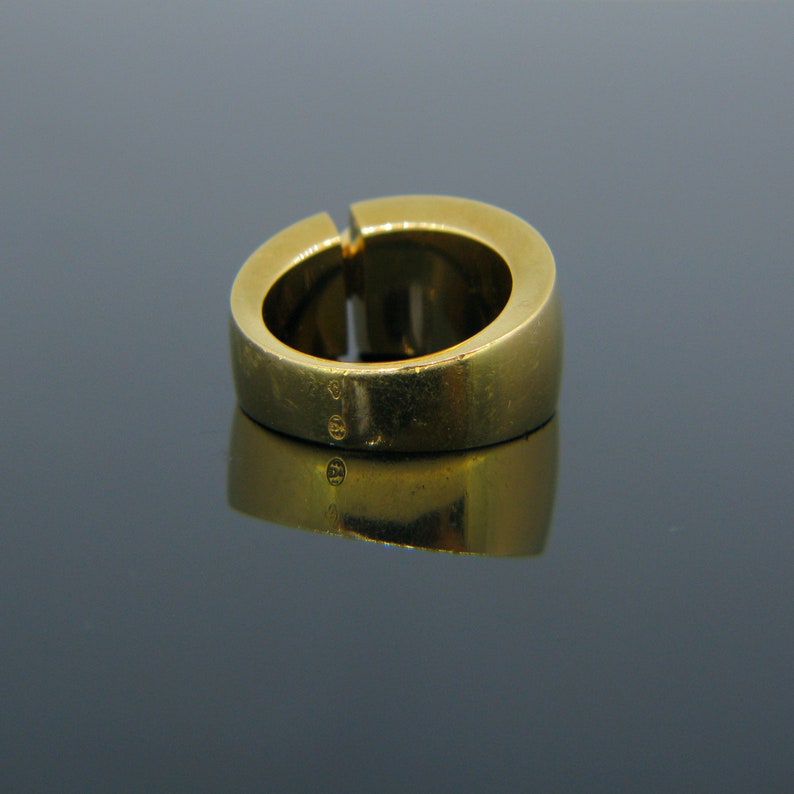 May include: A gold ring with a smooth, rounded band. The ring is marked with the number "585" on the inside of the band.