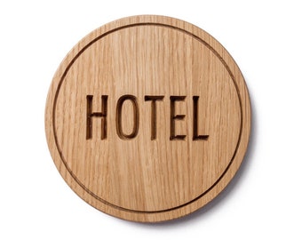 May include: A round wooden sign with the word "HOTEL" carved into it.