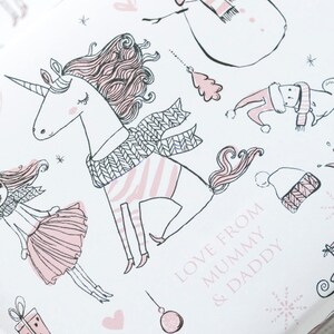 May include: A white background with a pink and white unicorn wearing a pink and white scarf. The unicorn has a pink mane and tail. The text "Love from Mummy & Daddy" is written in pink on the bottom right corner of the image.