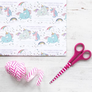 May include: White wrapping paper with a repeating pattern of colorful unicorns, rainbows, and stars. The text "Have a magical Christmas Emma Love Kate & William" is repeated throughout the paper.